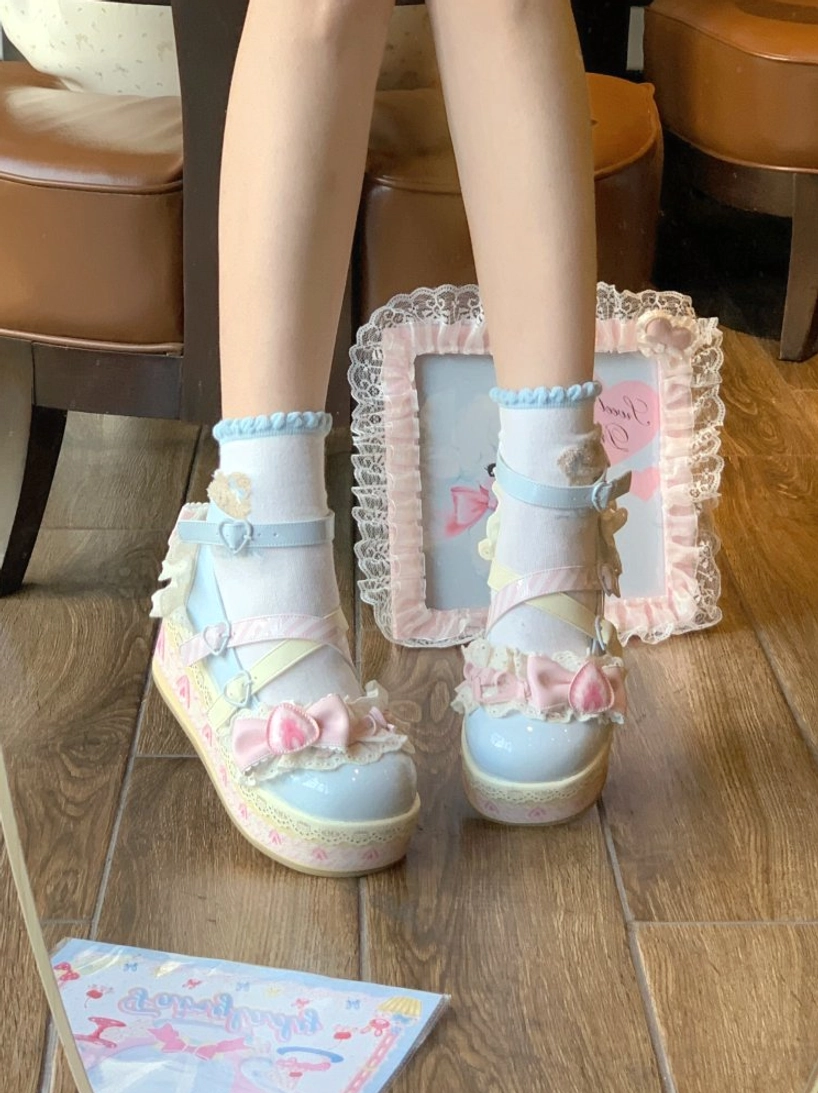 Blue-white sweet lolita platform shoes full leg overhead view on wooden floor with frilly ankle socks and thick platform sole decorated with pink bow and flowers