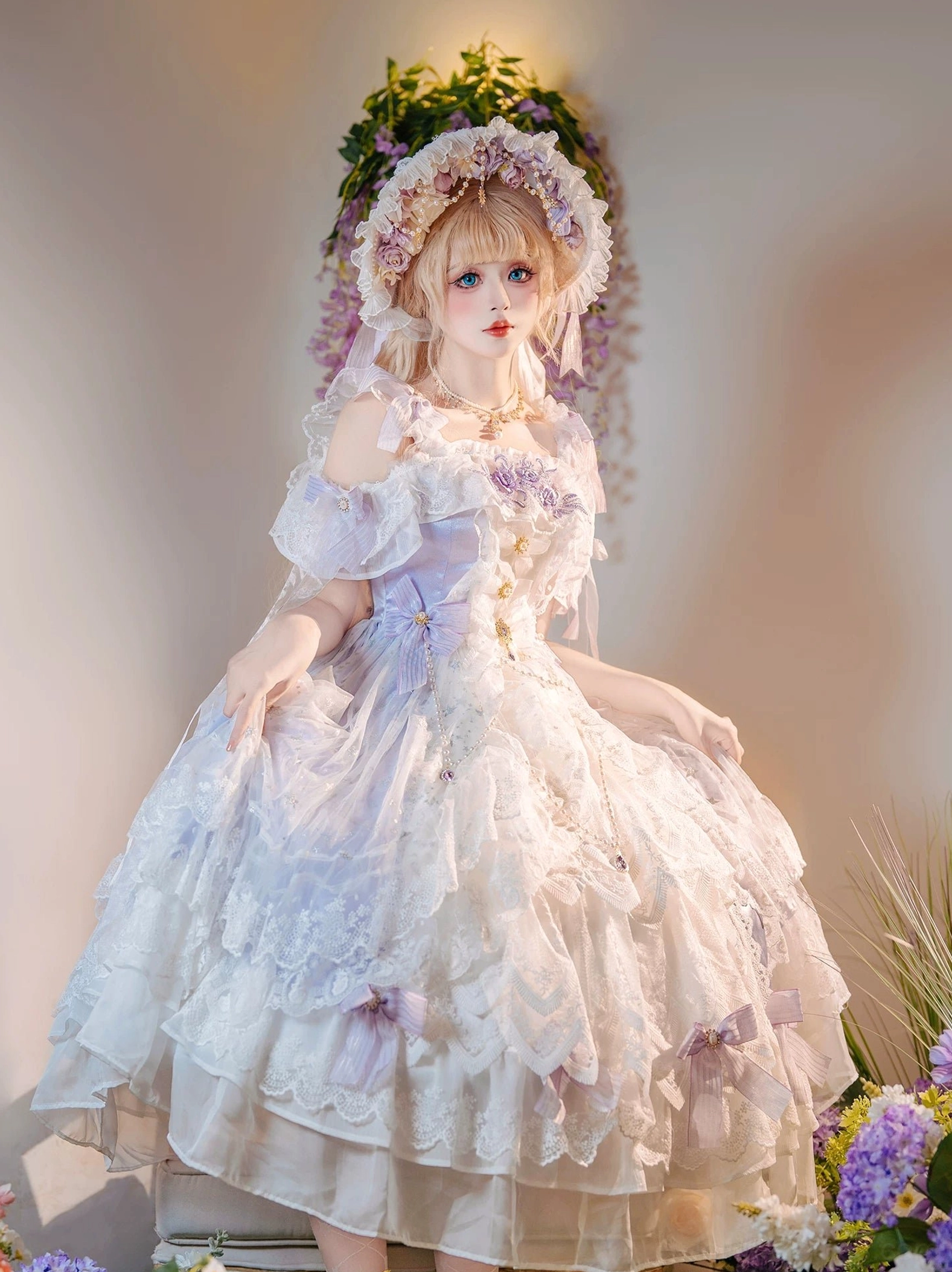 Seated bridal lolita gown showcasing cold-shoulder ruffled sleeves, gold decorative buttons, layered lace skirt with purple bows, low-angle front view on vintage chair