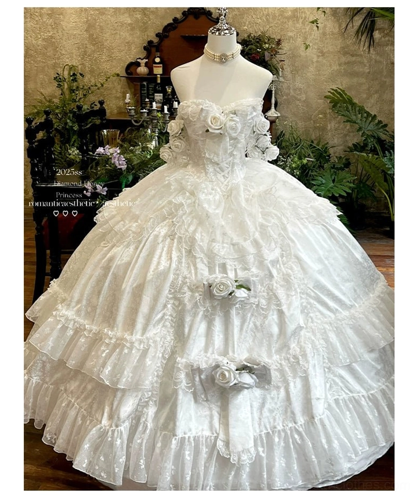 Back view of pastel pink bridal lolita wedding dress showing multi-tiered ruffled ball gown skirt