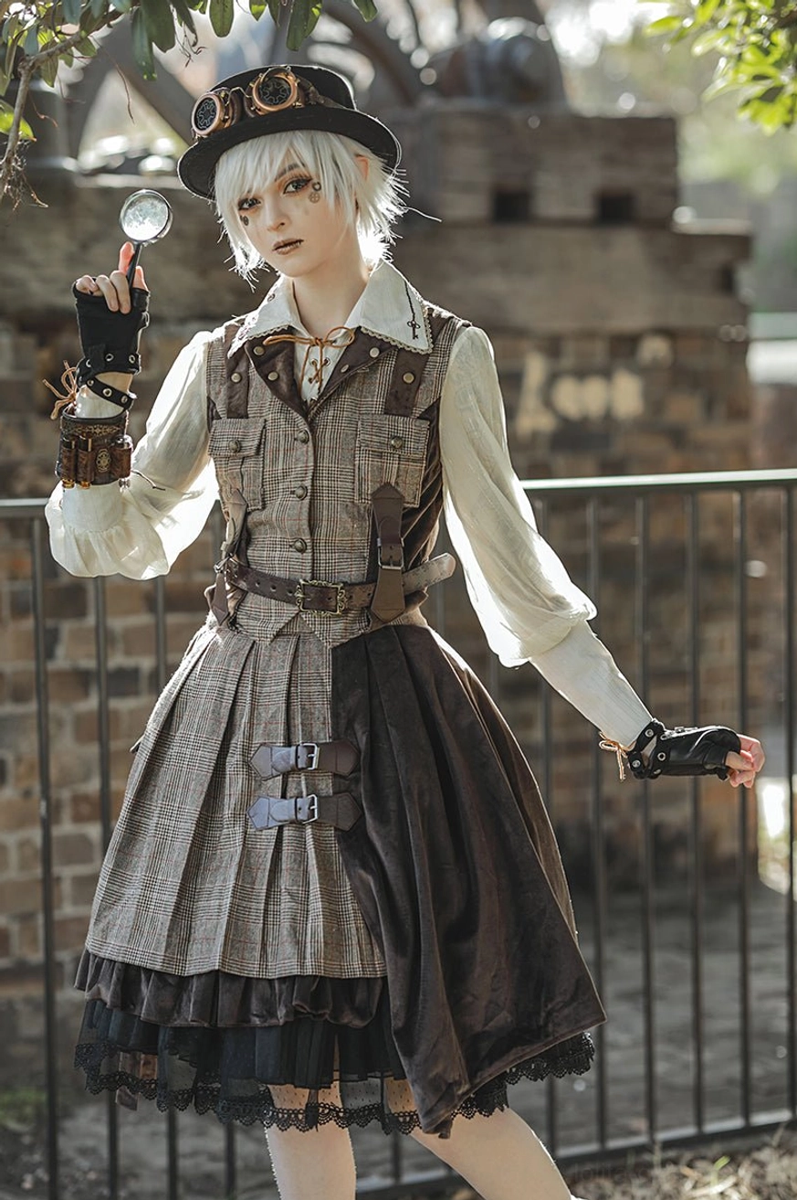 Front full-body model shot wearing British plaid punk lolita vest and brown velvet SK skirt with decorative waist belt, detective hat, and black boots against vintage industrial brick wall fence, steampunk coordinate styling