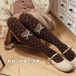 Brown polka dot lolita thigh high socks with bear bow applique worn over knee with beige sweater and fuzzy Mary Jane flats overhead view