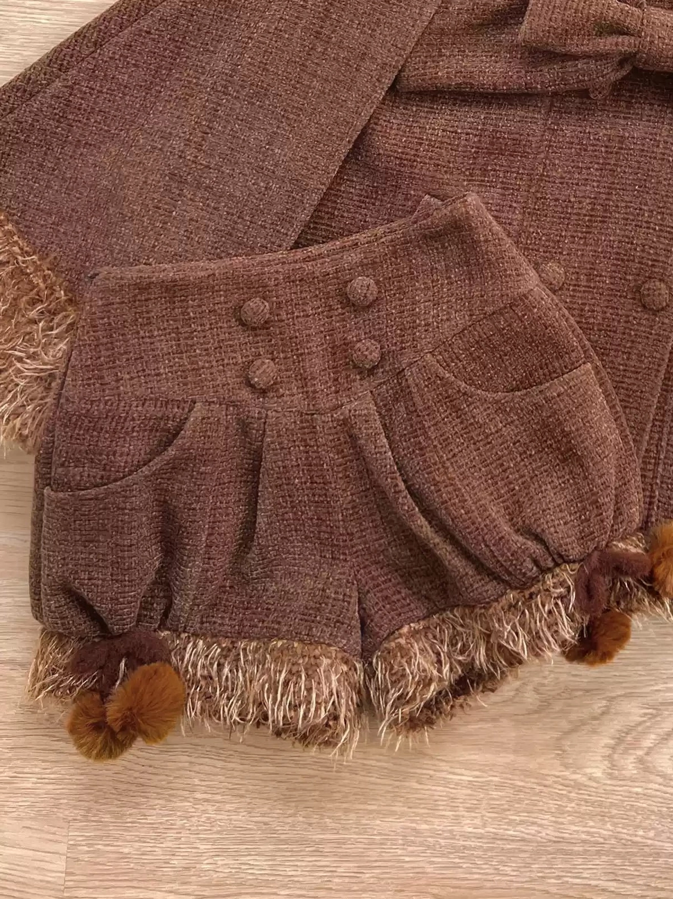 Brown bear pom-pom decorated lolita shorts isolated product shot showing fuzzy design elements structured waistband and leg construction on neutral background