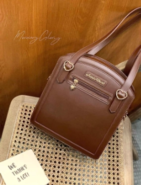 Brown solid checkered itabag side view flat lay rattan chair PU leather top carry straps heart shaped zipper pocket
