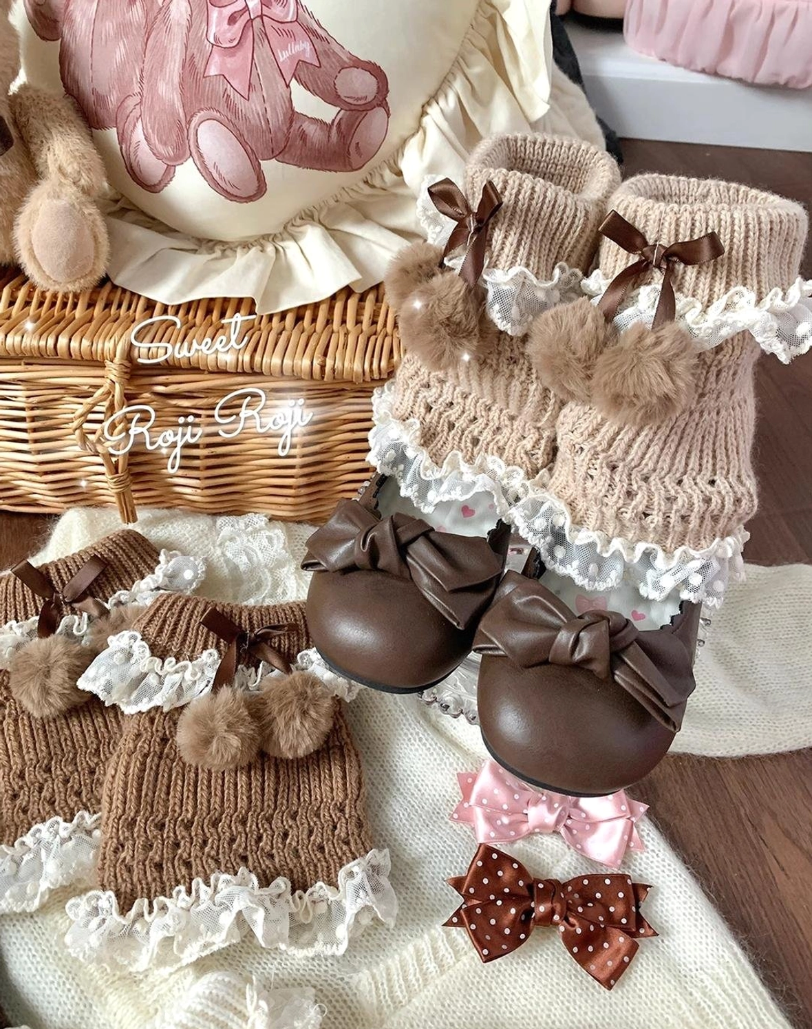 Brown lolita leg warmers and coordinating accessories in overhead flat lay with wicker basket, teddy bear props, and matching hair bows on vintage desktop