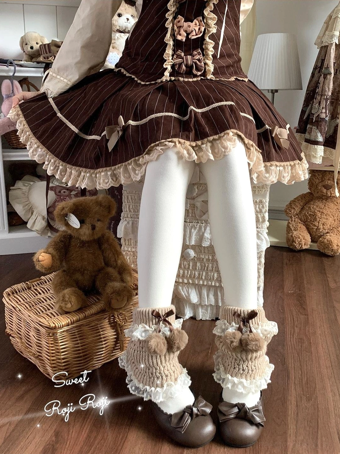 Brown lolita leg warmers with pom-pom details and lace ruffled cuffs worn with full brown frilled lolita dress, vintage dollhouse aesthetic styling