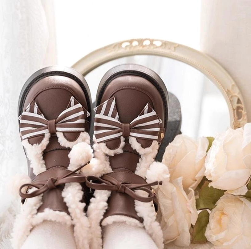 Top-down close-up display of brown lolita snow boots worn with white ruffled socks fuzzy fur collar bow strap decorations chunky platform sole vintage flower backdrop