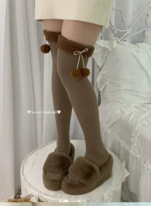Brown calf and over-the-knee Lolita fuzzy socks front view comparison, showcasing ribbed knit texture, white pom-pom decorations, and drawstring bow embellishments worn with mini skirt