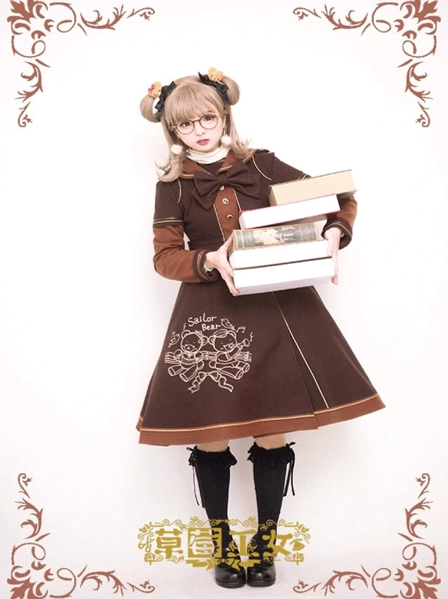 Brown sailor lolita coat with bow collar detail, button embellishments on chest, bear embroidery on skirt, paired with black knee-high socks, model holding stack of books