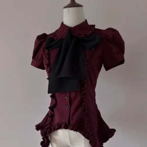 Burgundy gothic lolita short-sleeve blouse with ruffled hem and detachable bow-tie, front three-quarter view on dress form mannequin showcasing puff sleeve construction