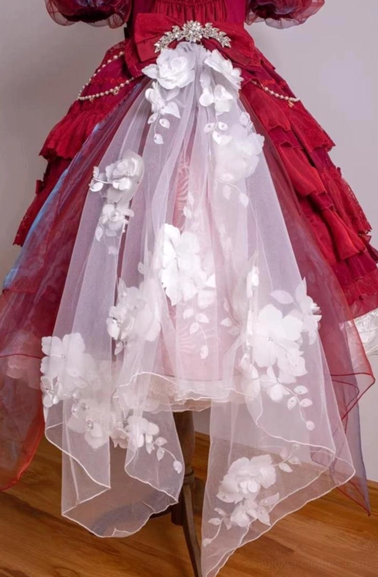 Lower skirt detail of burgundy classic lolita dress with asymmetrical sheer mesh train decorated with 3D white floral appliqués, pearl chain and rhinestone brooch embellishments