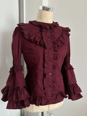 Burgundy old school lolita hime sleeve blouse with tiered bell sleeves and ruffled trims displayed on dress form, left three-quarter view showing princess sleeves and fitted silhouette