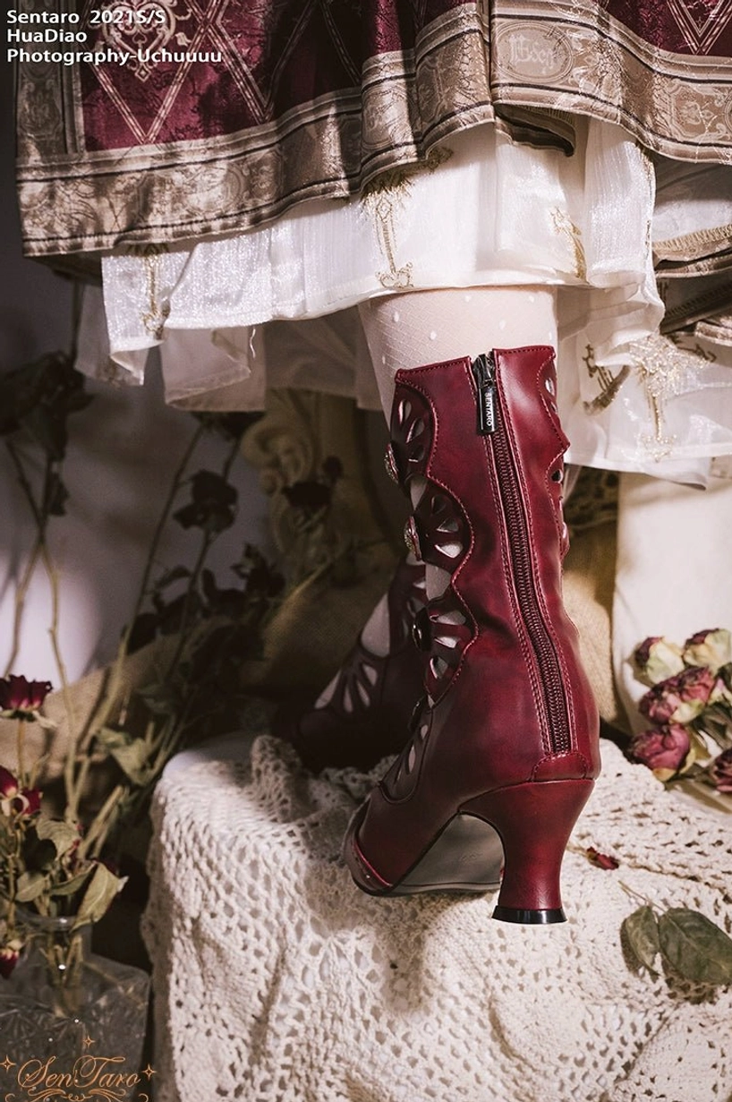 Rear three-quarter view of burgundy Lolita Mary Jane boot showing side ankle zipper curved heel and hollow carved decorative straps detail
