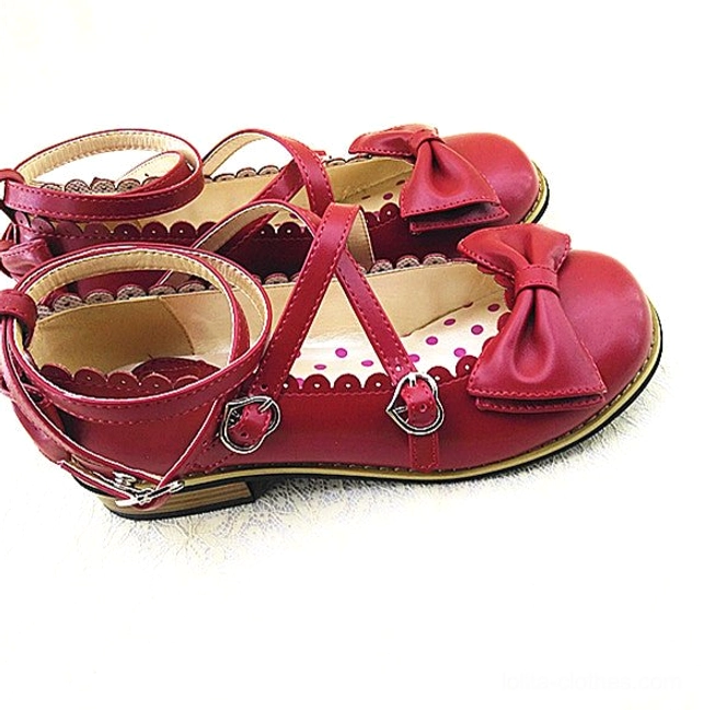 Burgundy red Lolita low heel princess shoes with cross red ankle straps and metal buckles, red bow vamp decoration, scalloped shoe edge trim, and polka dot inner lining