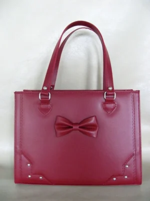 Burgundy solid color structured Lolita tote bag with dimensional bow decoration and corner rivets front view