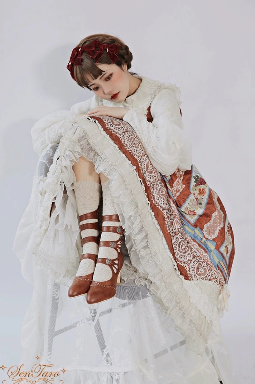 Burgundy vintage Lolita Mary Jane boots floral hollow-out straps with retro metal buckles close-up photography detail view