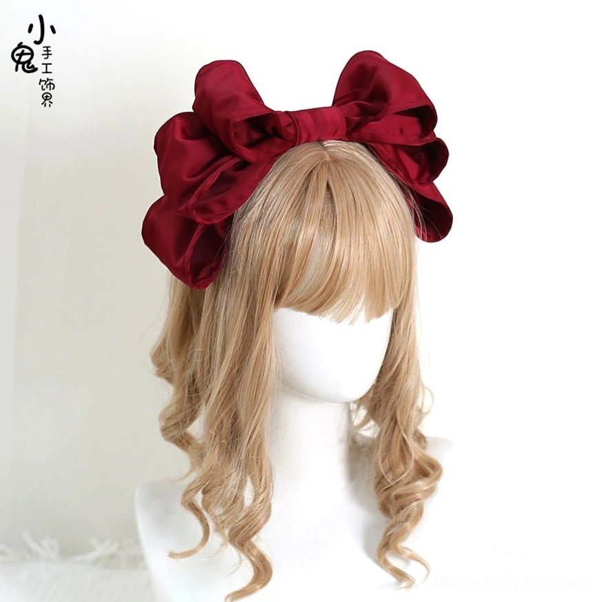 Deep wine red burgundy oversized satin bow Lolita hair clip frontal close-up on mannequin blonde wig rich glossy satin layered big bow