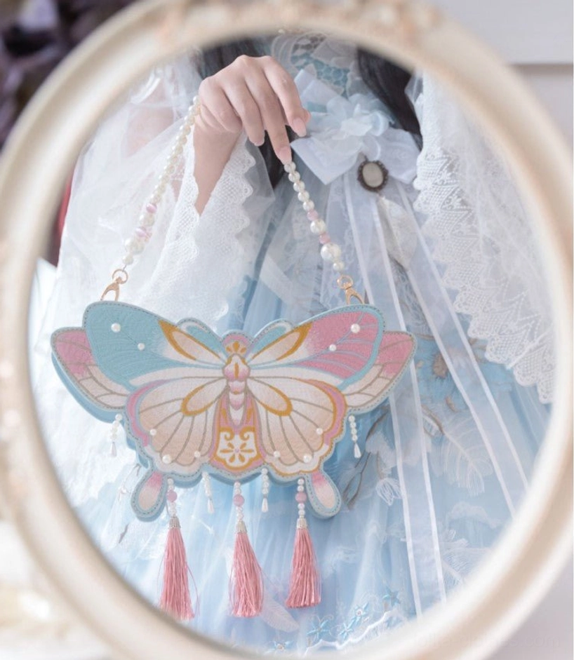 Chinese Qi Lolita butterfly bag size reference showing proportions relative to standard objects for scale comparison