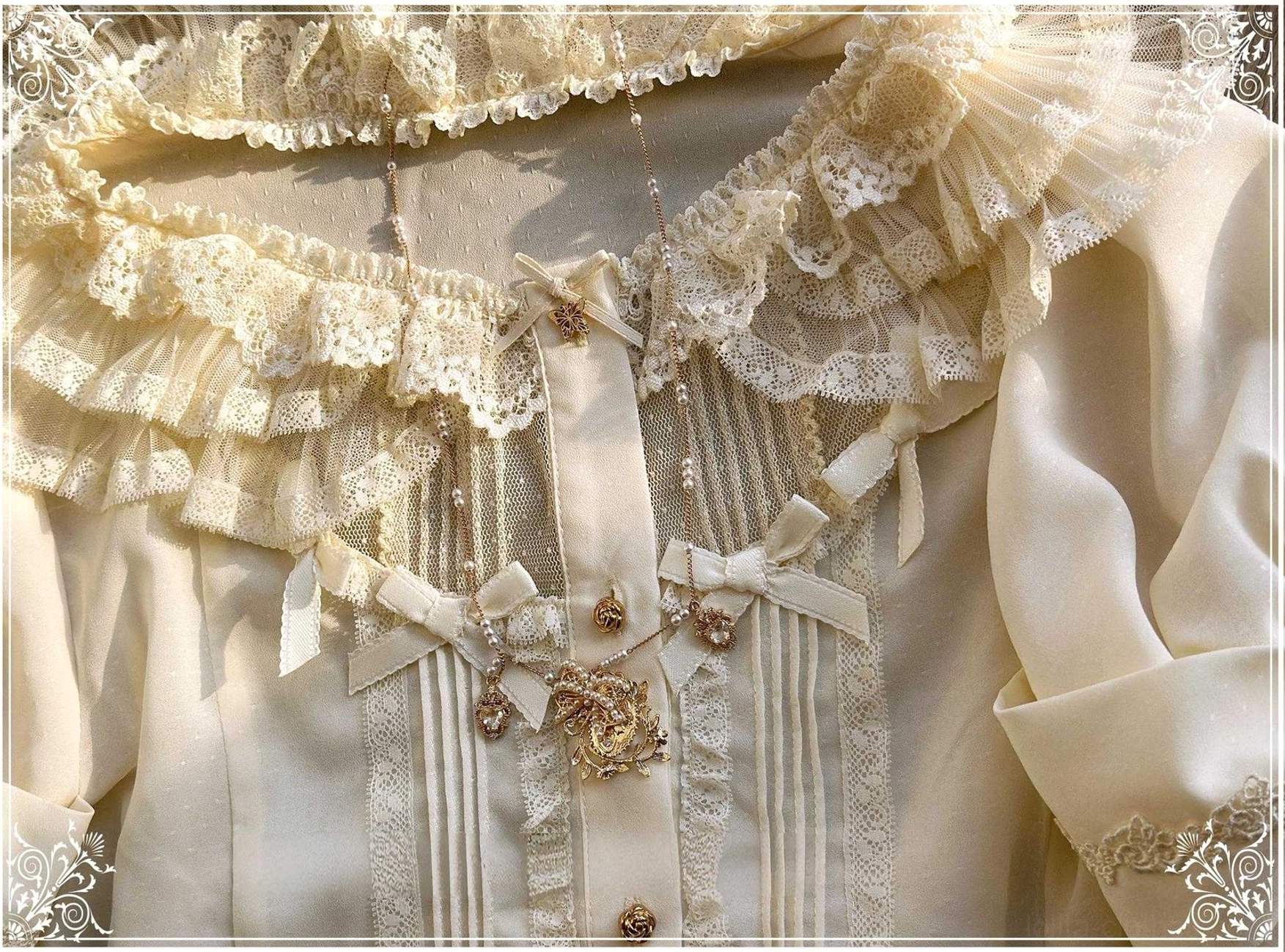 Close-up detail of butterfly shadow blouse multi-layer lace placket, gold decorative rose and butterfly buttons, pintuck fabric stripes on creamy off-white blouse