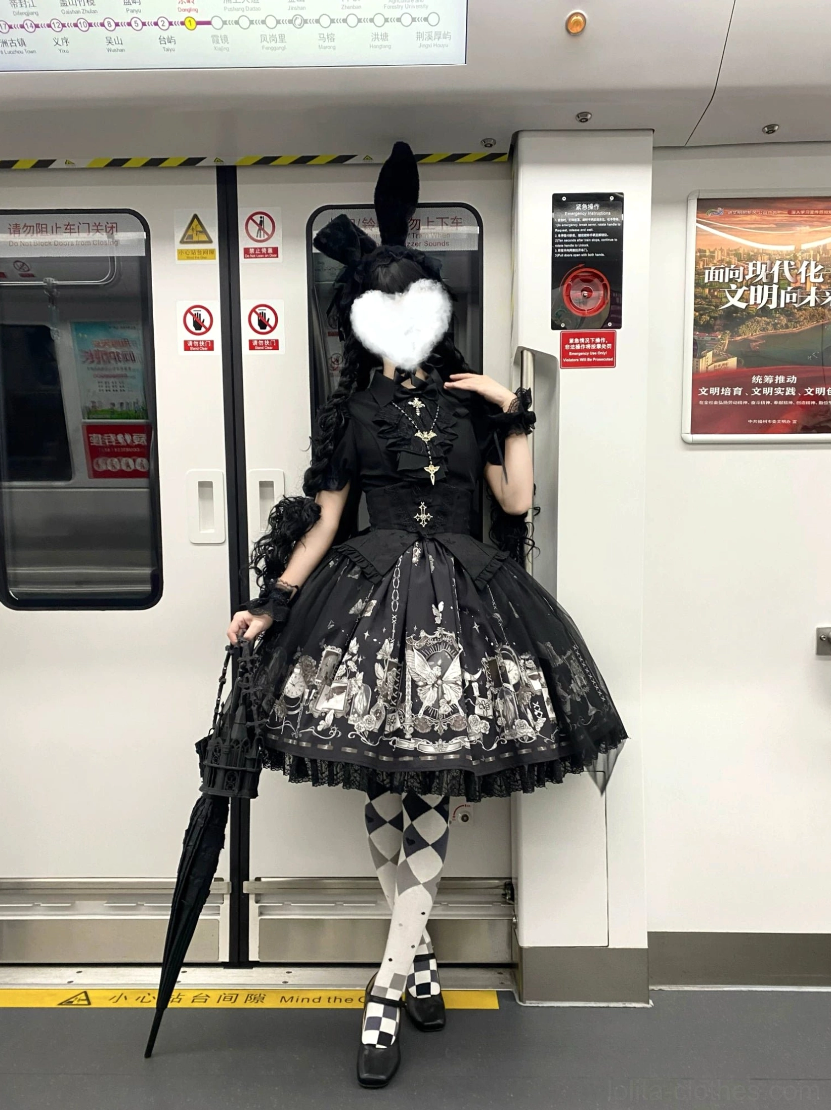 Worn butterfly shadow gothic lolita complete outfit side view subway platform featuring bunny ear headpiece heart face cover argyle stockings