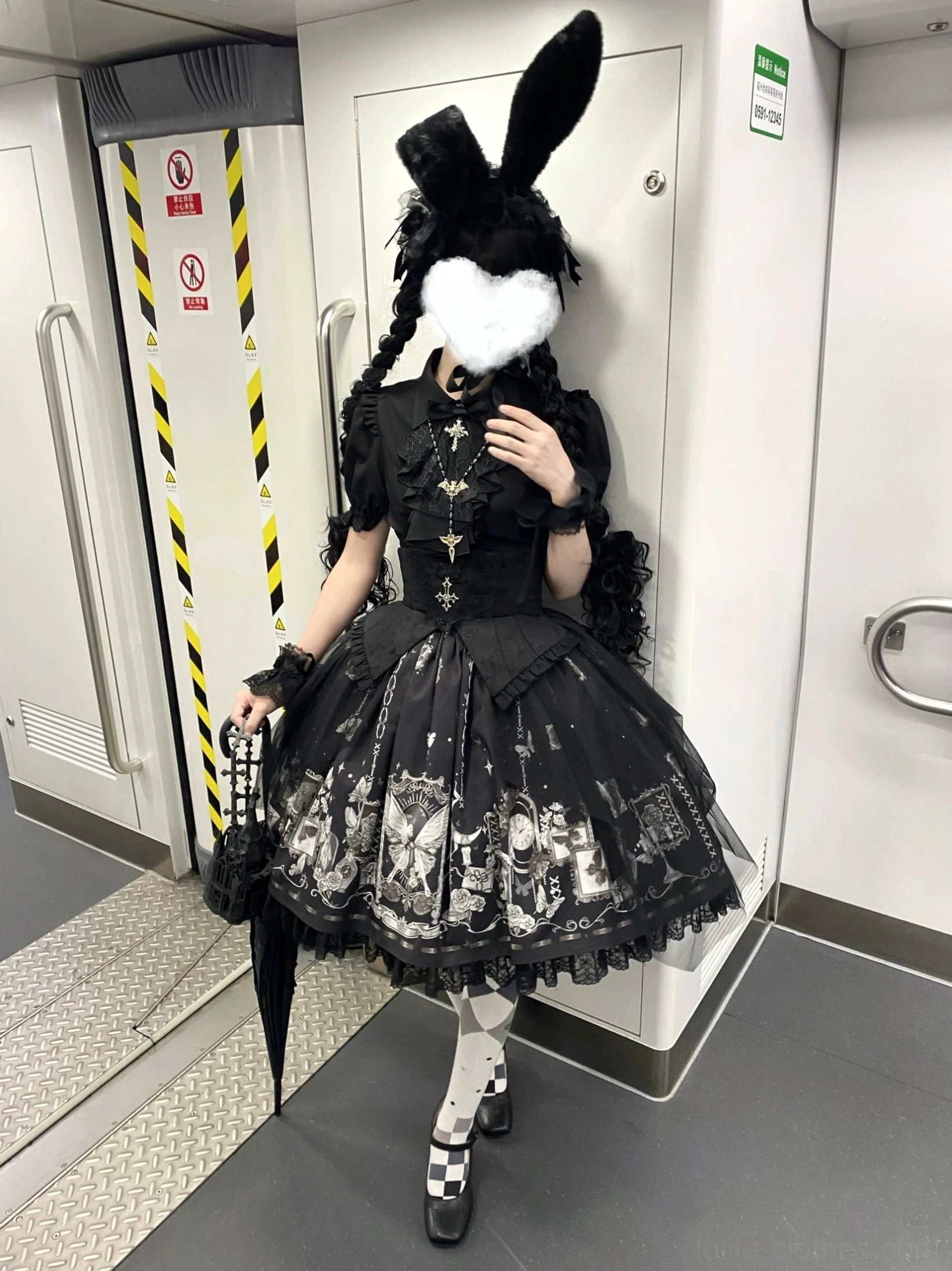 Worn butterfly shadow gothic lolita ensemble front view indoor subway area with heart face covering checkered platform mary jane shoes corset skirt