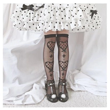 Calf-length Lolita knee socks in classic black bow on black background colorway with sheer glass yarn material and decorative heart motifs