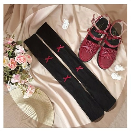 Calf-length Lolita socks featuring bold red bow on black background with polka dot heart motifs in premium glass yarn sheer construction