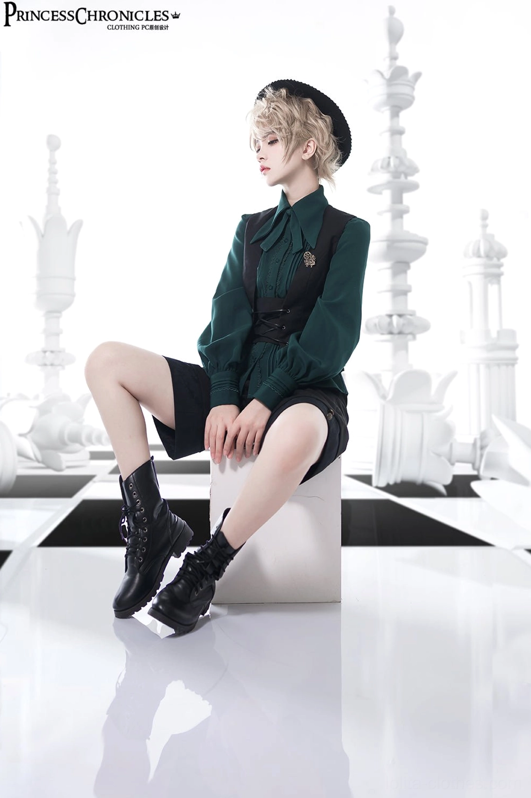 Side view of a casual Ouji Lolita coordinate featuring black waistcoat shorts combat boots and antique bronze waist accessory