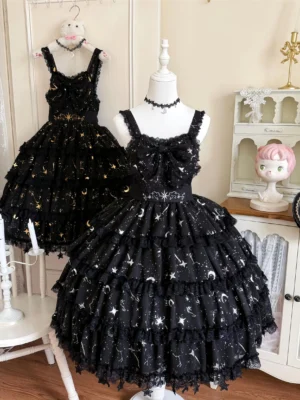 Celestial Whispers classic lolita chiffon JSK dress with gold and silver star moon foil stamping on black fabric displayed on two dress mannequins in vintage studio setting with layered ruffled skirt and lace trim details