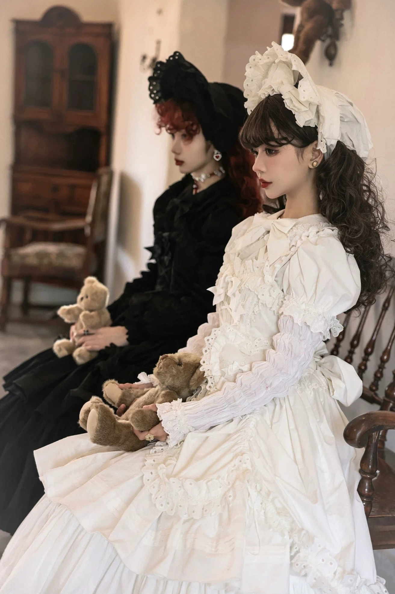 Three-quarter side view of champagne Lolita JSK on mannequin showing sheer long sleeves, ruffled collar, and delicate lace decorations