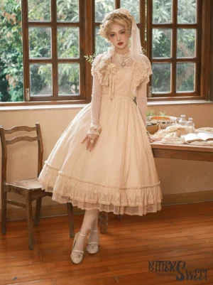 Champagne vintage Lolita OP dress full-length three-quarter side view with ruffled lace skirt hem, floral chest decoration, sheer wrist cuffs, worn with matching light beige high-heeled shoes in vintage European dining room