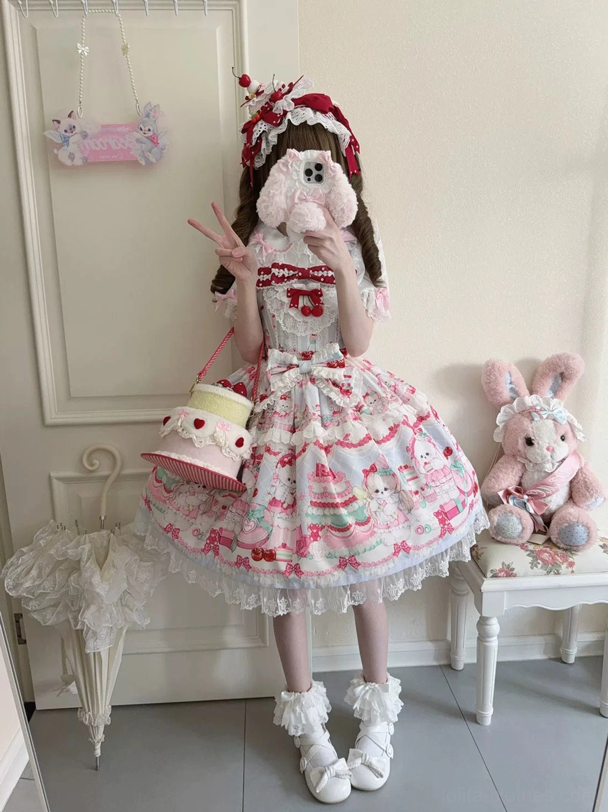 Cherry Bake Song Kawaii Lolita Jumper Skirt in red white colorway, full-body front view model wearing white fluffy boots with cake-shaped handbag, featuring detailed lace neckline trim and bow embellishment