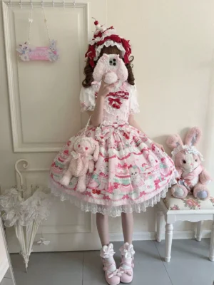Cherry Bake Song Kawaii Lolita Jumper Skirt in light pink white colorway, full-body front view with model wearing burgundy headbow and fluffy pink shoes, showcasing delicate animal and cake print with lace collar trim