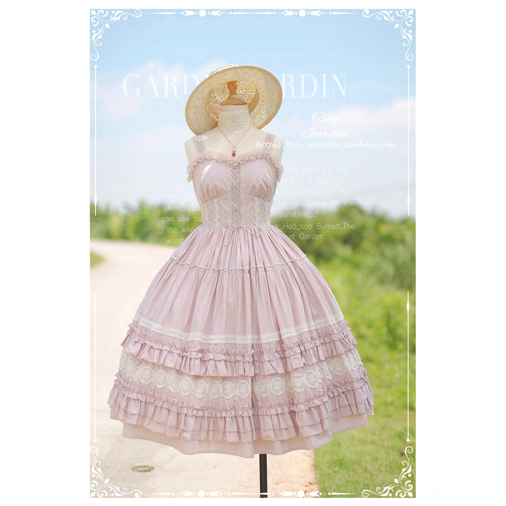Cherry blossom pink lolita JSK jumper skirt dress with sweetheart neckline spaghetti straps and voluminous ruffled skirt, displayed on mannequin in outdoor rural garden setting with straw hat styling accessory