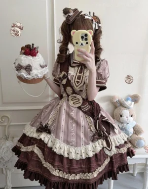 Model wearing chocolate cone lolita OP dress with brown twin ponytails and detachable sash, holding dessert prop from behind