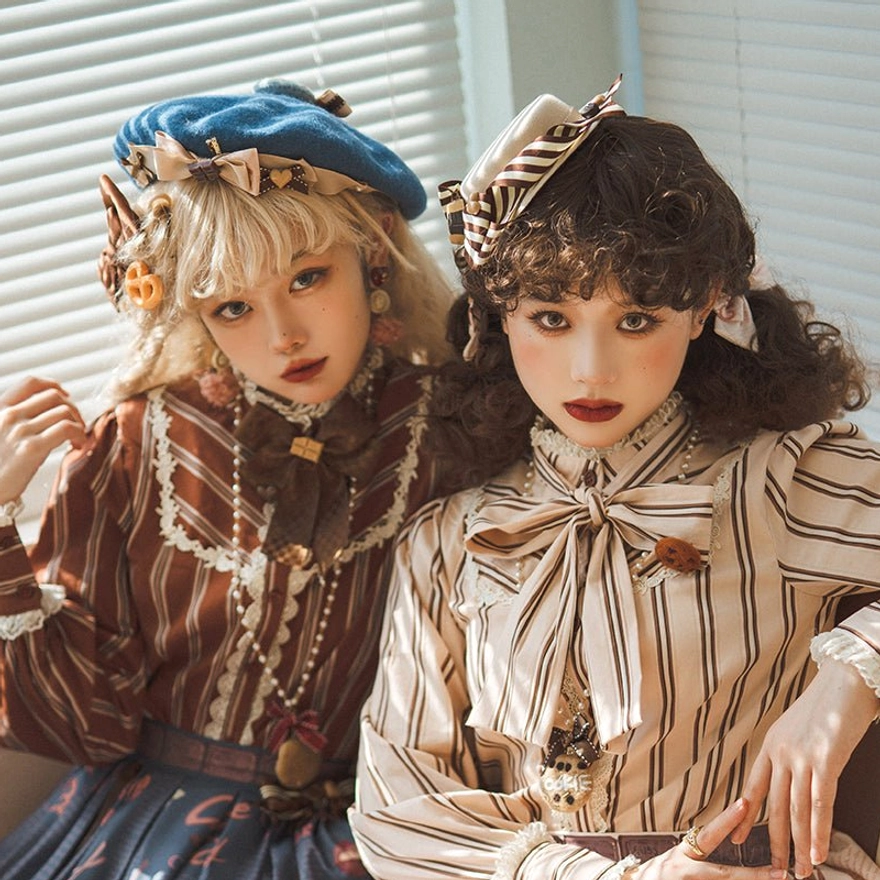 Two lolita models in sweet lolita berets with striped bows and flower decorations, wearing striped blouse coordinates, photographed against indoor blinds window background for daily wear styling