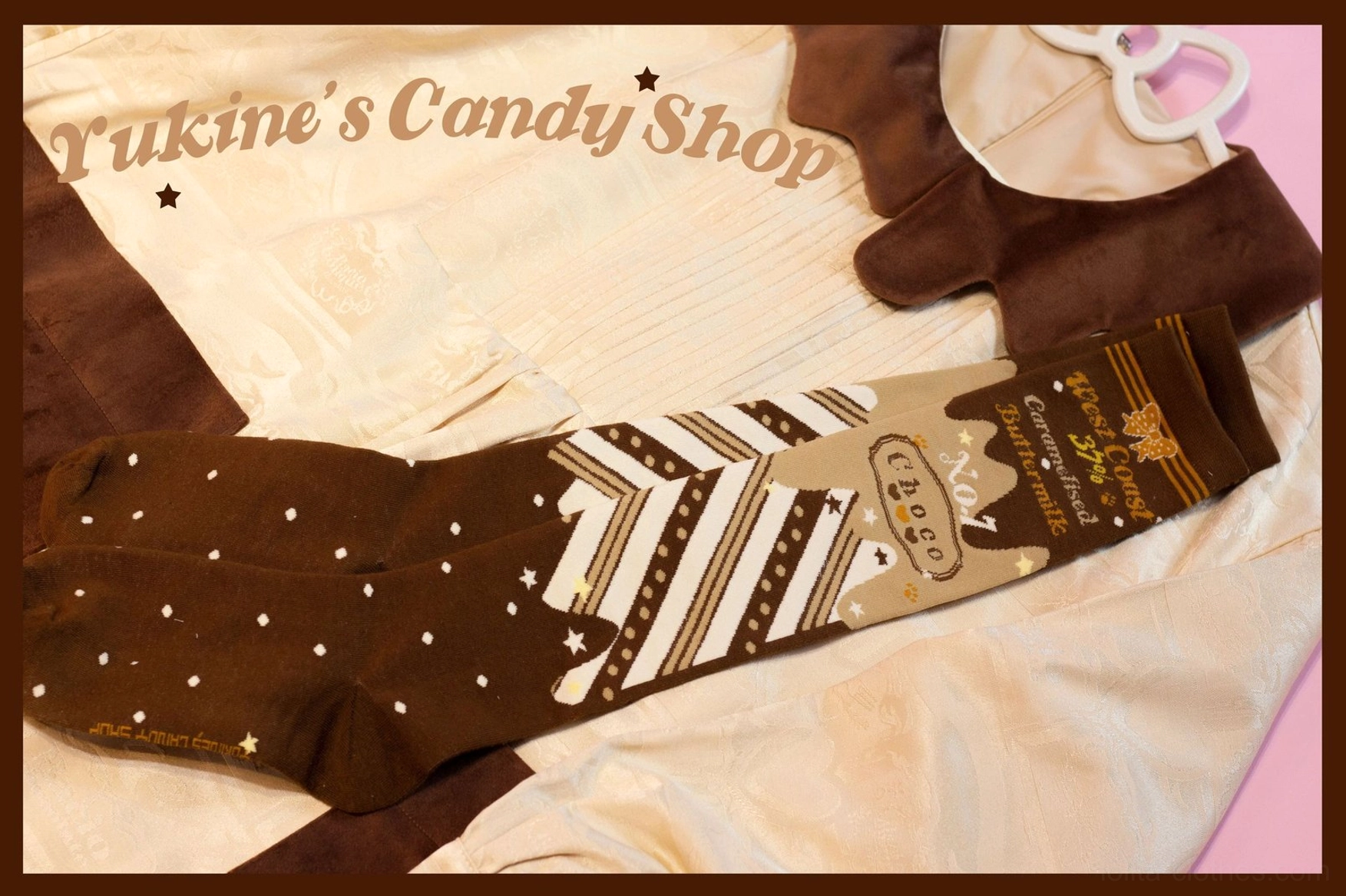 Chocolate lolita cotton socks top-down flat lay on light pink studio backdrop with clothes hanger prop polka dot striped design