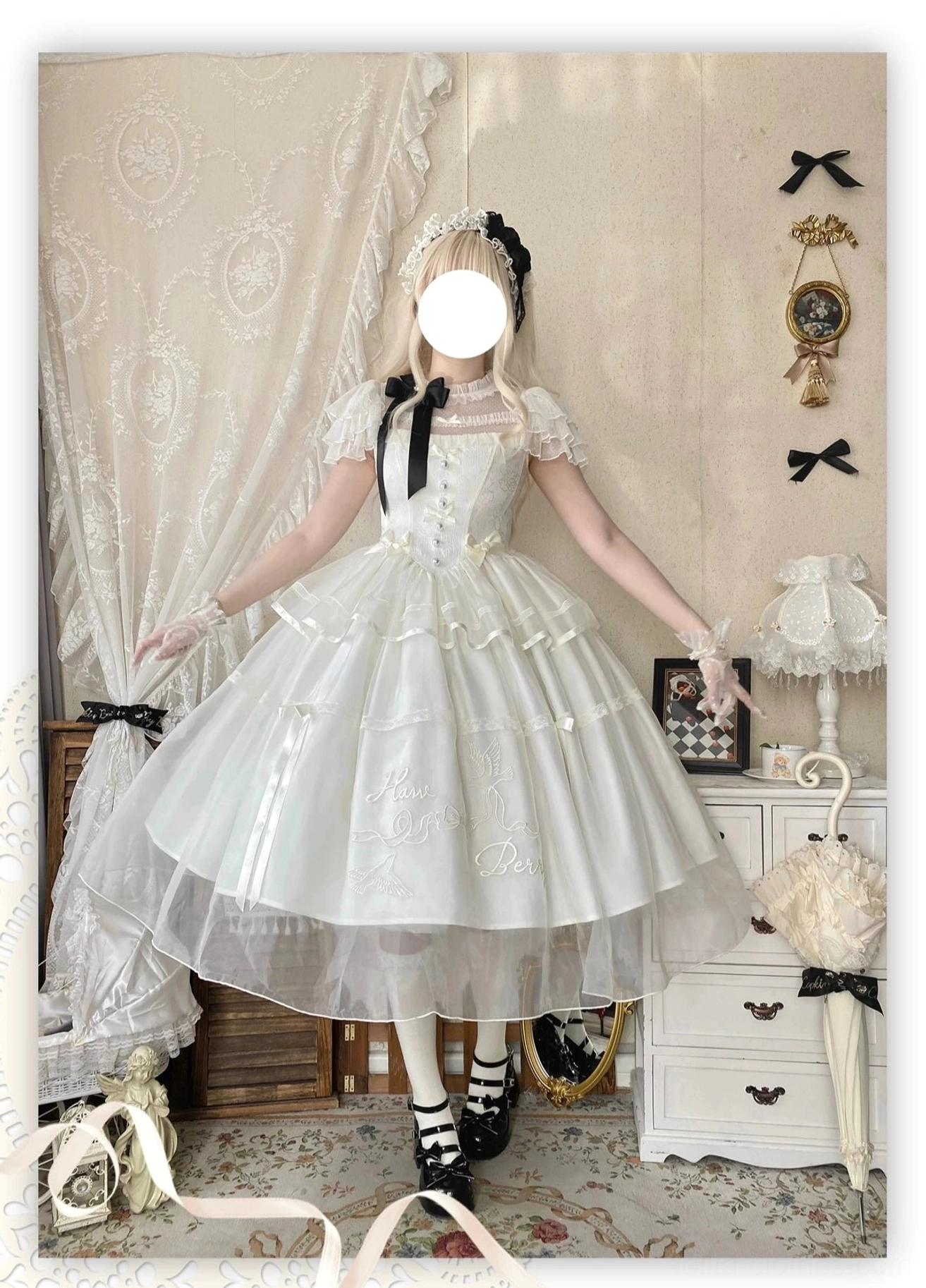 Model wearing milky apricot classic lolita OP dress with black bow, ruffled short sleeves, sheer tulle overskirt, mary jane shoes and socks indoor bedroom
