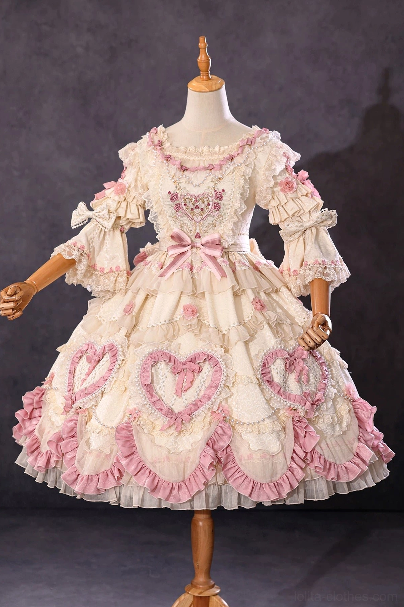 Classic Lolita bonnet flat lay showing intricate lace pattern and ribbon bow construction detail