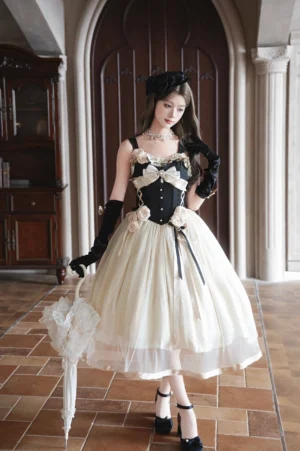 Classic Lolita corset JSK dress front view with cream and black color block design, 3D fabric roses at waist, large bust bow, model wearing black opera gloves and holding lace parasol in vintage mansion hallway