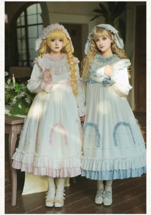 Classic lolita doll-like OP dress in white and blue with ruffled collar and skirt embroidery, shown on two models wearing matching bunny ear hairbands in vintage wooden sitting room