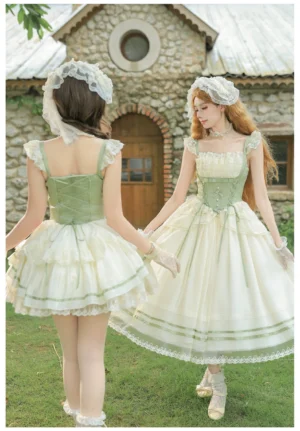 Back view of two models showcasing classic lolita dress with lace-up back corset design, ruffled shoulder straps, and layered tiered skirt hem with green ribbon trim detail