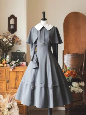 Front view classic lolita OP dress dusty blue with white peter pan collar detachable cape long sleeves box pleats A-line midi skirt vintage metal button details