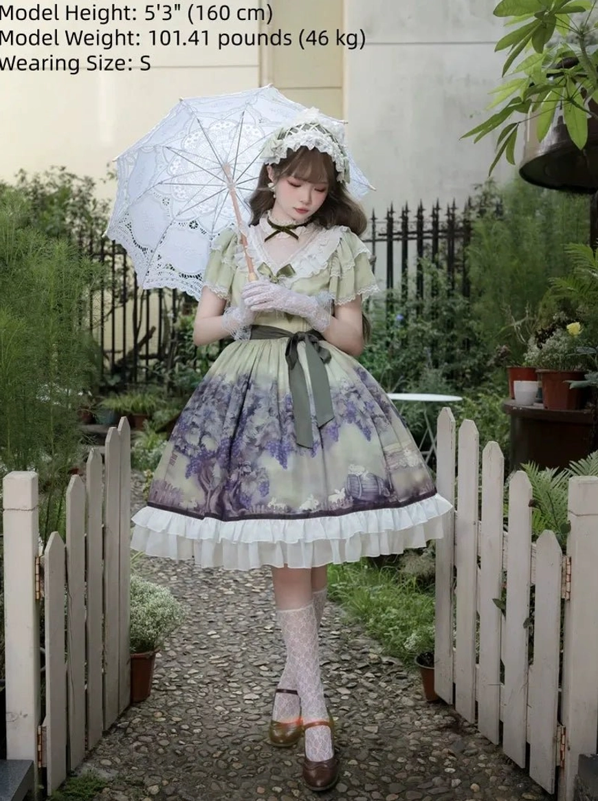 Front full posed view of classic lolita OP dress with model holding lace parasol in garden setting with picket fence background, fitted bodice, flared skirt with matching waist bow sash and coordinated hairpiece