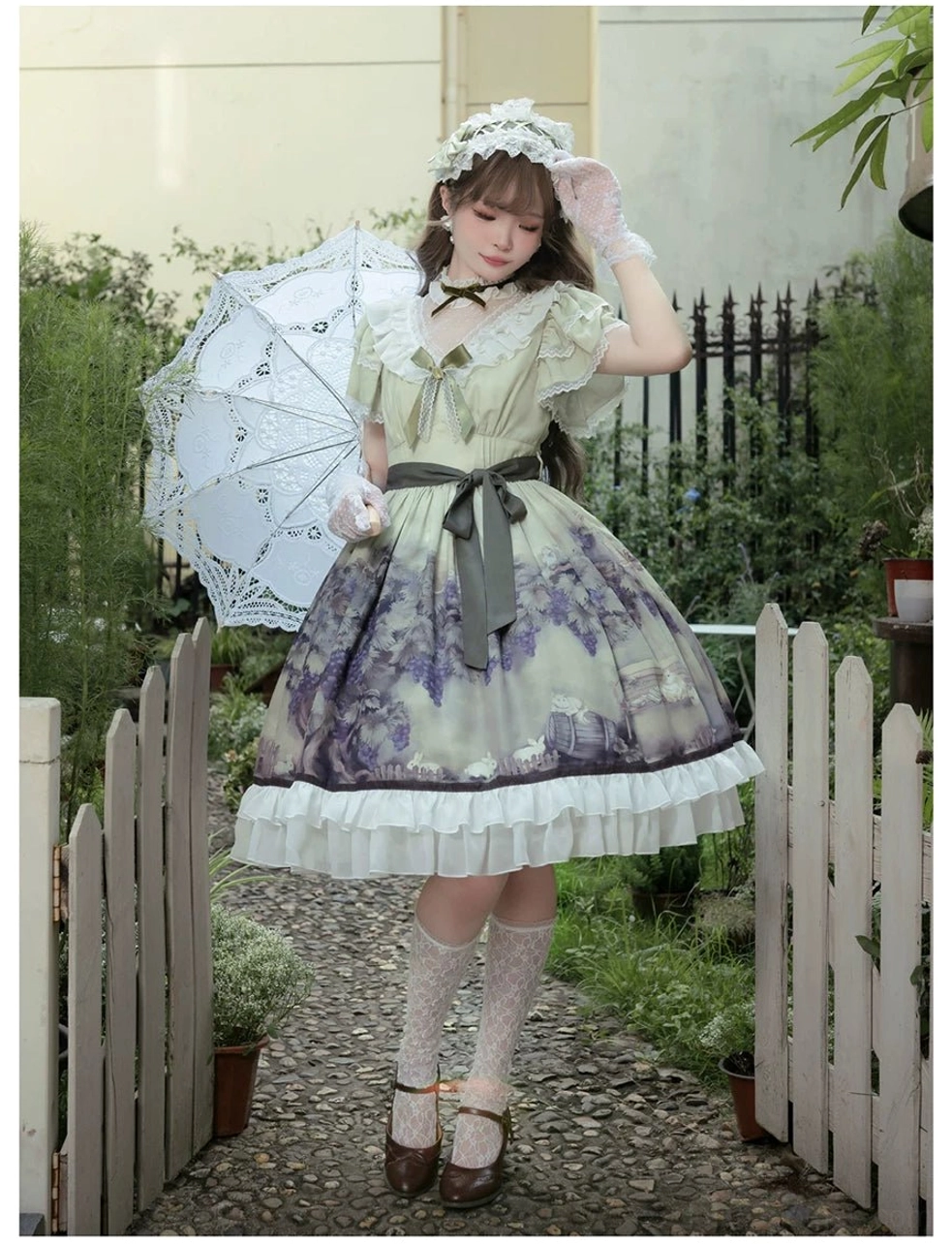 Close-up flat view of dress skirt watercolor style purple grape and floral print pattern on sage green fabric base, showing botanical print detail and color accuracy of classic lolita OP