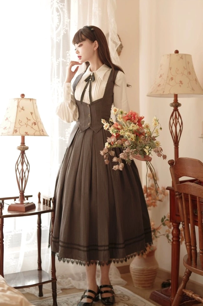 Full-body Classic Lolita outfit set with cream lace-trimmed pointed collar shirt, dark brown pleated midi suspender skirt with lace hem, standing in vintage home studio with table lamps and flower bouquet