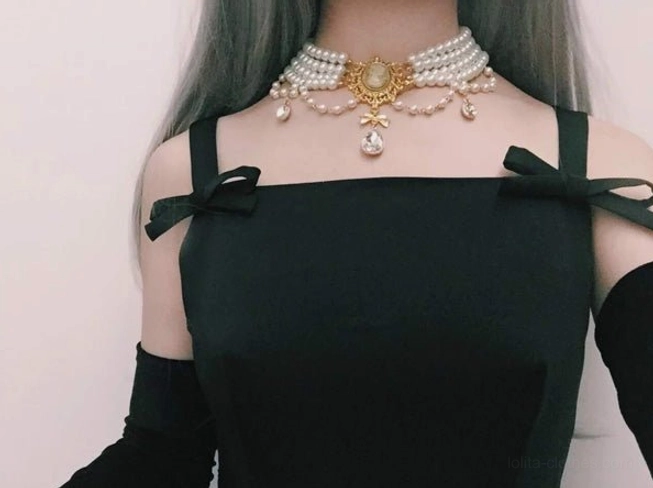 Styled flat lay arrangement of classic Lolita pearl choker necklace with vintage accessories, ornate frame elements, lace details, and romantic background creating complete Victorian-inspired aesthetic coordination inspiration