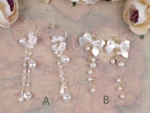 Classic Lolita pearl rhinestone dangle earrings vintage romantic style comparison flat lay with roses and antique map background showing style A flower design and style B white bow design