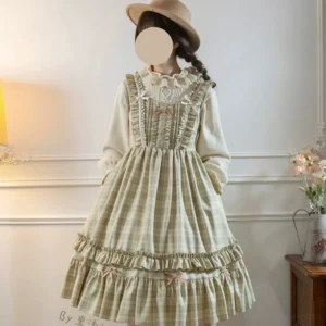 Plus-size classic lolita plaid JSK jumper skirt in green featuring high-waisted A-line silhouette with tiered ruffled details and decorative ribbon bows, front three-quarter view on model