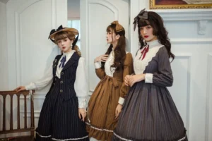 Models posing in vintage indoor room setting with antique furniture wearing classic striped lolita outfits with bow neckties and vertical pinstripes