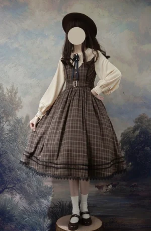 Classic lolita tartan jumper skirt dress with v-neckline full body side view on model wearing vintage styling with bowler hat white socks and leather flats